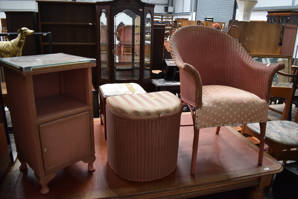 A vintage Lloyd Loom chair, retailed by Day, a similar linen stool and a woven fibre bedside chest