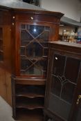 A late Victorian/Edwardian mahogany corner wall display cabinet having astral glazed door