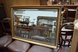 A large modern gilt frame wall mirror, some distressing, approx. 70 x 100cm