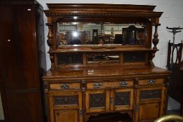 A Victorian walnut and mahogany mirror back sideboard, having detailed carved panels and probably