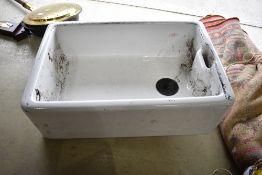 A selection of Belfast style sinks of various sizes including a pair of brackets and plumbing parts