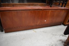 A vintage stained frame low sideboard having flap fronts, width approx. 153cm