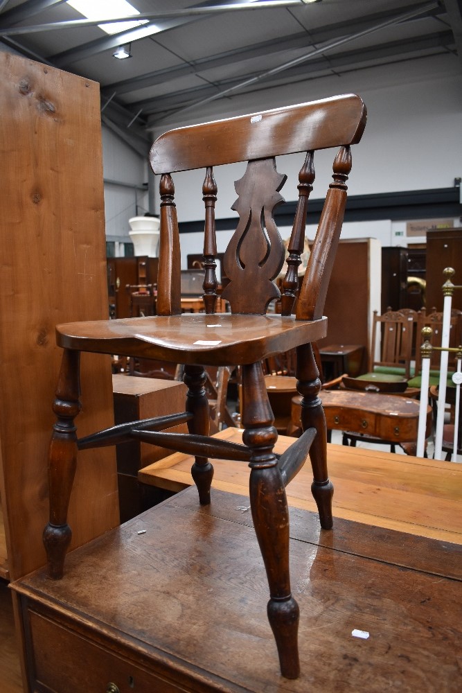 A traditional kitchen chair having mahogany frame and turned supports