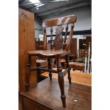 A traditional kitchen chair having mahogany frame and turned supports