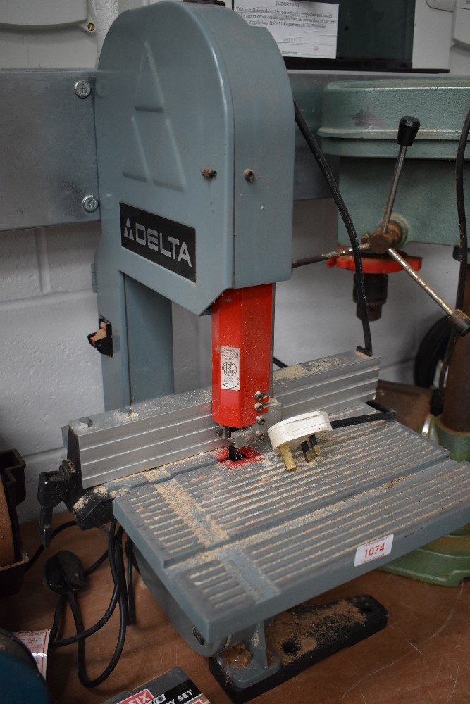 A work bench mounted Delta band saw