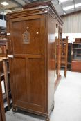 A mid 20th Century oak hall robe, width approx. 74cm, on casters