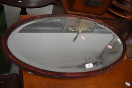 A stained frame oval wall mirror, width approx. 72cm