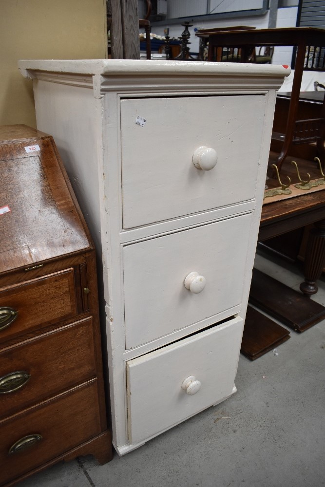 A set of office white painted yellow pine drawers with turned handles