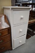 A set of office white painted yellow pine drawers with turned handles