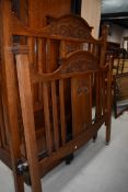 An Art Nouveau oak bedstead, having carved motifs, width approx 137cm (4ft6in Double), complete with