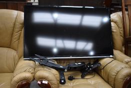 A modern 40 inch flat screen television and wall bracket with remote