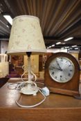 An early 20th Century oak cased mantel clock and a painted metal table lamp