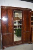 An early 20th Century mahogany triple mirror door wardrobe, width approx. 154cm