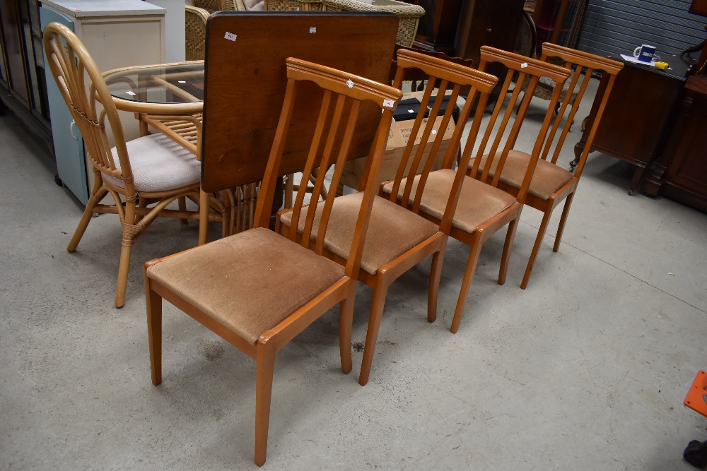 A set of four modern beech wood kitchen chairs with rail back