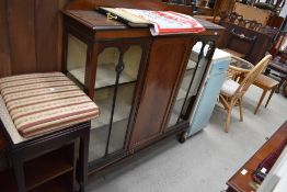 An early 20th Century mahogany display cabinet having ledge back, central cupboard flanked by