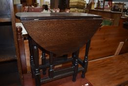 A mid 20th Century dark oak gateleg occasional table, width approx. 67cm