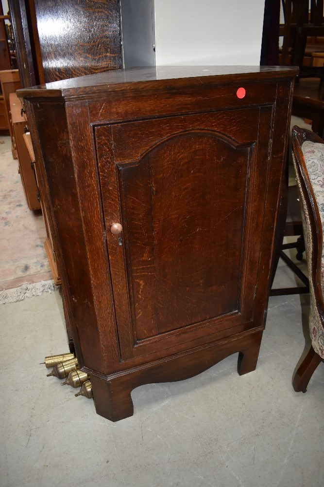 An oak corner cupboard base unit