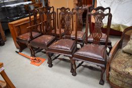 A set of six plus two carver mid Victorian dining chairs having ball and claw feet with fretted