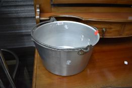 A large metal cooking or camping pan