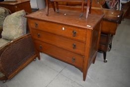 An early 20th century oak chest of three drawers on tapered legs