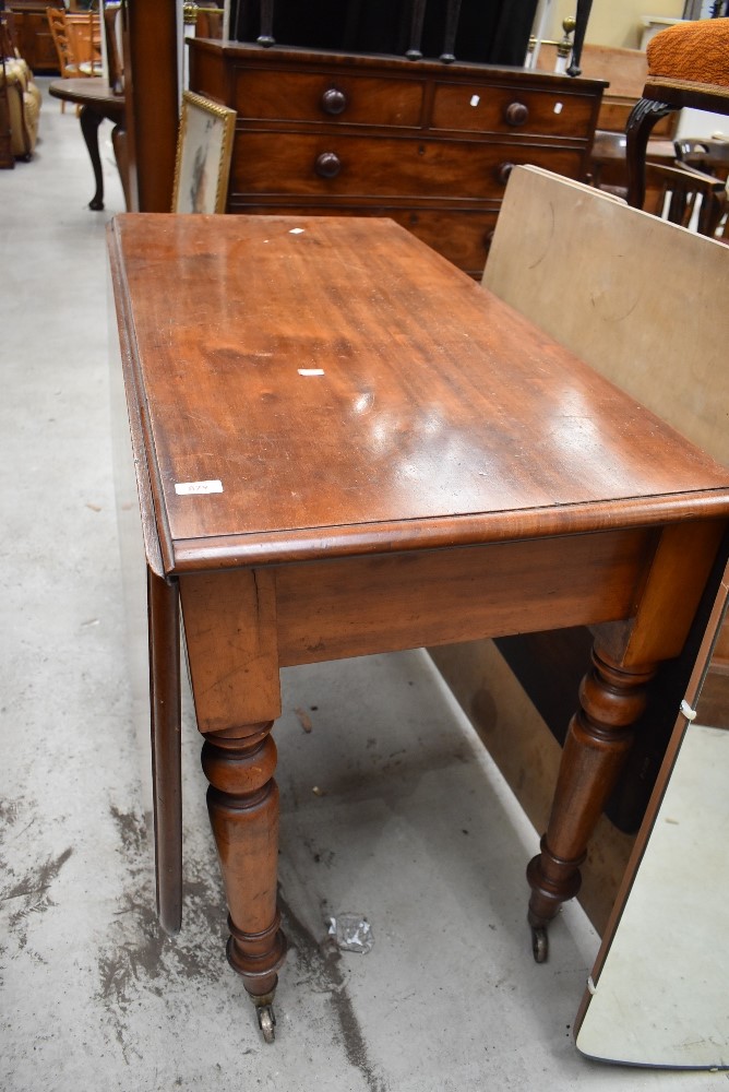 A late C19th/early C20th drop leaf dining table on turned legs, approx w 106cm