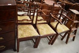 A set of five (four plus one) early 20th Century mahogany dining chairs having slit ladder backs