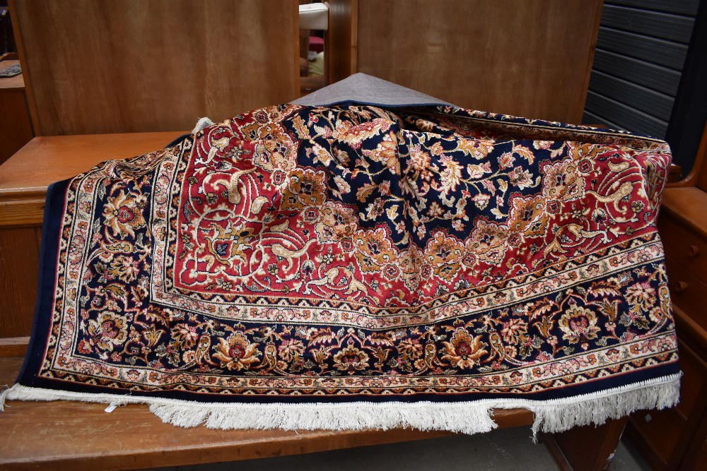 a large carpet square or rug having Turkish design with deep blue and burgundy ground