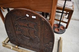A carved oak fire screen arch top with storage flap to back, width approx. 66cm
