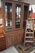 A modern laminated display case and dresser base unit having glazed and illuminated cabinet