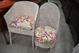 Two woven fibre tub chairs one in a nursing design and similar arm chair styled one labeled Lloyd
