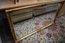 A large over mantle mirror having wooden and gilt gesso frame with bevel edged mirror approx 130cm x