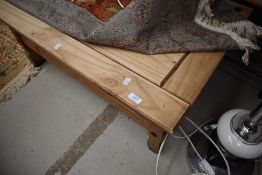 A rustic coffee table with frieze drawer