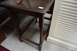 An Edwardian hall or tea table having barley twist legs on oak frame work