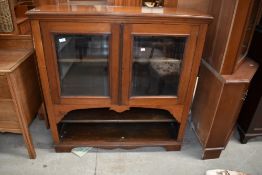 A 19th Century mahogany bookcase , glazed section over two open shelves , possibly on later base,