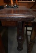 A square early 20th century kitchen preparation table having turned legs on oak framework