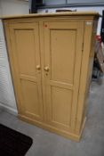 A painted pine shelved cupboard or utility storage
