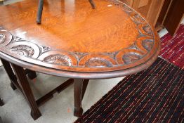 An early 20th Century carved oak gateleg dining table