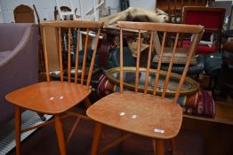 A pair of mid century laminated wood kitchen chairs