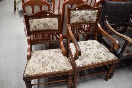 A 19th Century mahogany upholstered armchair having semi spindle back, and a matching nursing chair