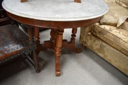 A 19th Century marble top circular dining table having composite wood base