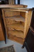 A stripped pine corner cupboard with glazed removable doors