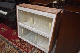 A 1950's 60's atomic style glazed book case or utility cupboard