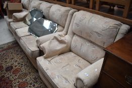 A modern three piece lounge suite having cream upholstery, very clean and tidy