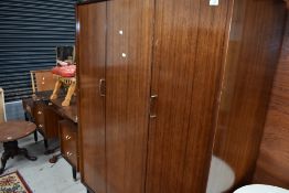 A vintage bedroom suite by E Gomme, G Plan, compsrising wardrobe, dressing table, double bed frame