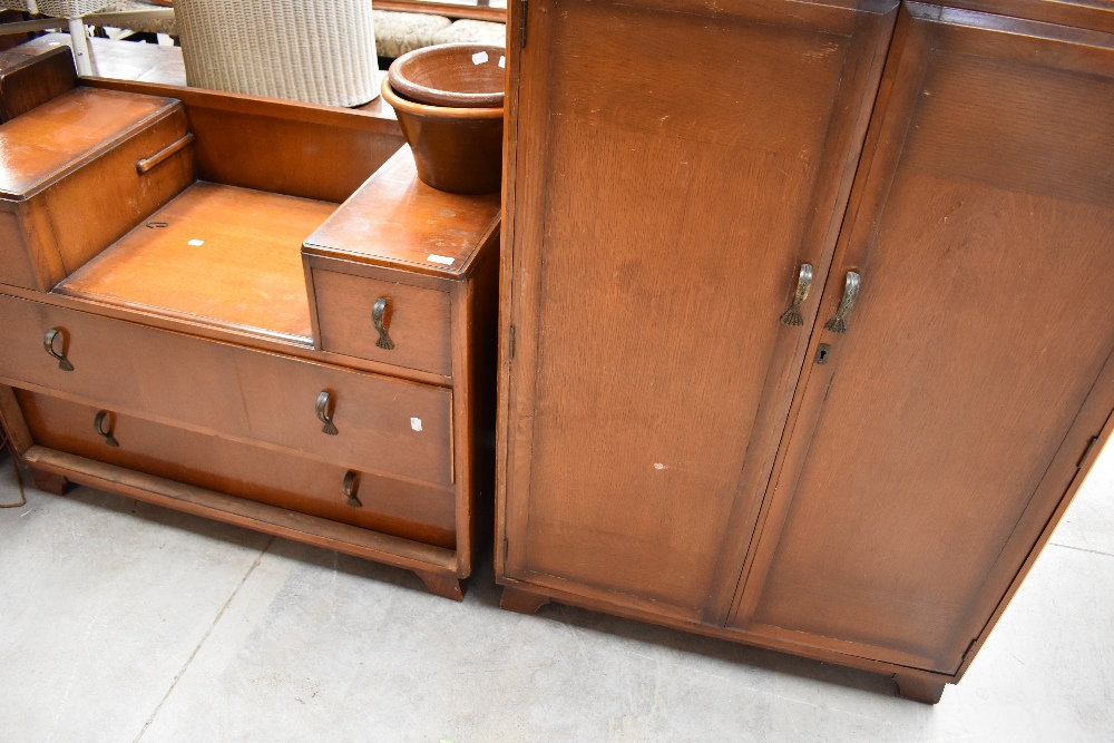 An early to mid 20th Century golden oak dressing table and tall boy
