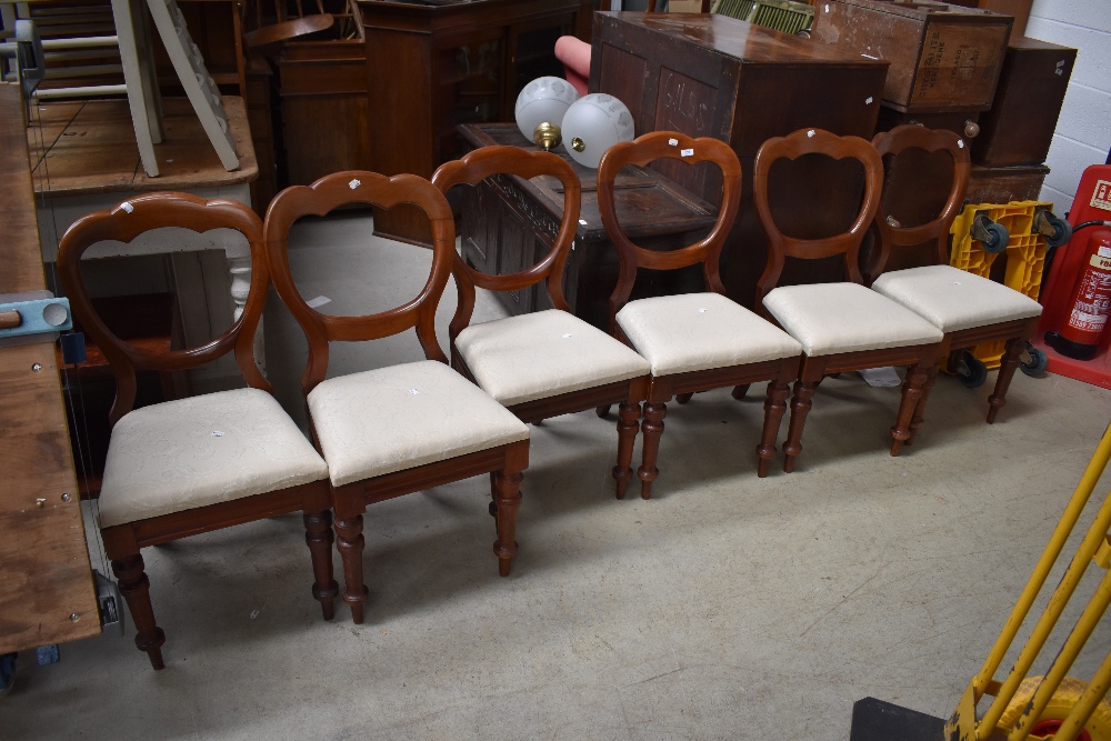 A set of six Victorian mahogany balloon back dining chairs, unstamped with four having bolts to rear