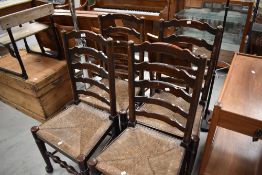 A set of four traditional rush seated ladderback chairs