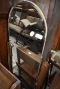 An early 20th Century full length mirror on oak supports