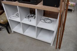 A modern modular shelf unit with wood effect top and six open 33cm shelves, probably suitable for