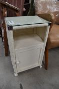 A woven fibre bedside or bathroom cabinet with cupboard base